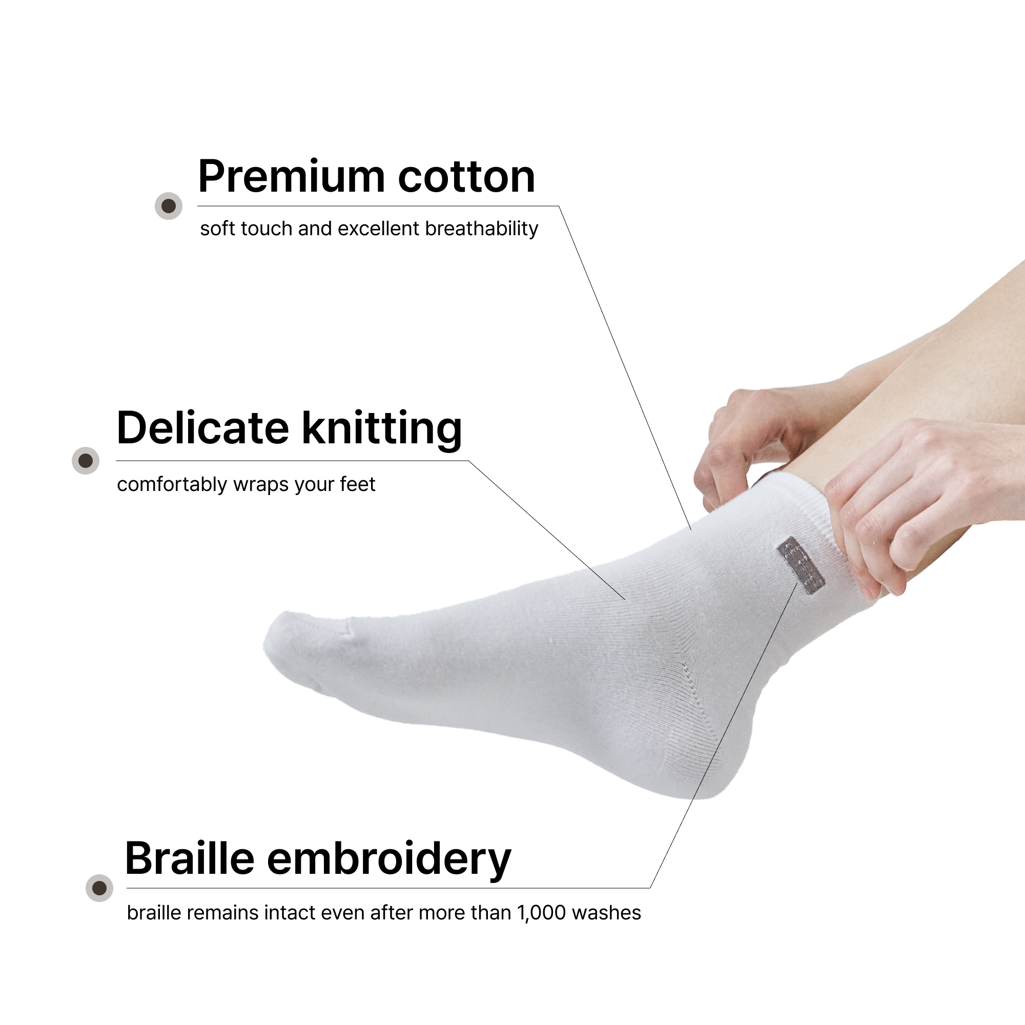 A person's leg and hands putting on a white premium cotton ankle sock featuring delicate knitting and a dark grey embroidered braille label